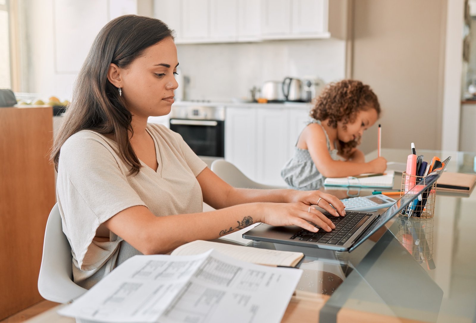 Mom working from home with distance learning child, multitasking childcare and work life balance du